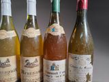 several bottles of wine are lined up in a row on a table