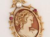a close up of a picture of a woman with a pearl in her hair