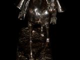 statue of a man riding a horse on a black background