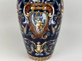 a blue vase with a picture of a woman on it