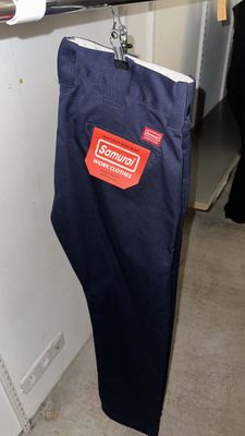 a pair of blue pants hanging on a clothes rack