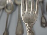 a lot of silver spoons and spoon spoons on a table