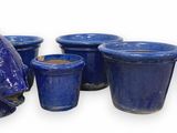 many blue vases and vases with fish heads on them