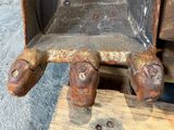 a rusted piece of metal sitting on top of a piece of wood