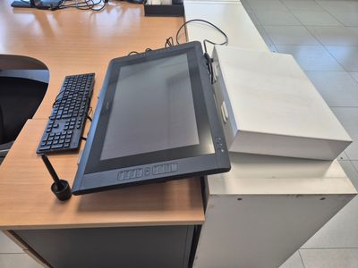 a tablet computer sitting on top of a desk next to a keyboard and mouse
