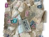 a pile of old postage stamps on a white surface