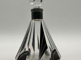 a glass bottle with a black and white design on it