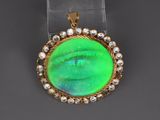 an oplite and diamond pendant