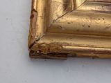 a picture of a gold frame on a white table