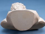 a white sculpture of a man with a head on a cloud