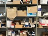 boxes and other items are stacked on a shelf in a room