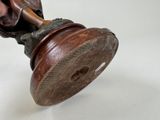a statue of a person holding a wooden object
