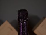 a bottle of wine sitting on top of a wooden table