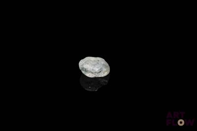 an image of a white rock on a black surface