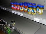 many jars of food on the shelves in the store