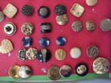 many different types of buttons on a red surface