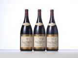 three bottles of wine are lined up on a table
