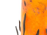an orange vase with a black design on it