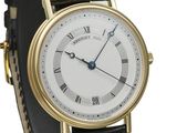 a close up of a gold wrist watch with roman numerals