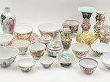 many different types of bowls and vases on the table