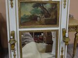 a picture of a mirror with a painting on it