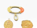 three pieces of gold and coral jewelry including a ring, a coin, and a bracelet