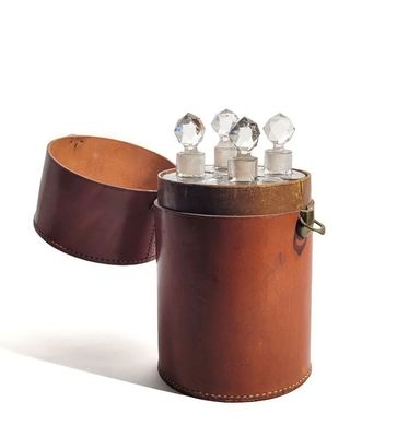 a leather case with three glass bottles inside of it