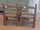 two wooden chairs sitting next to each other on the floor