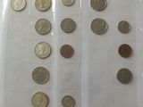 a lot of coins in a plastic container on a table