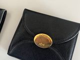 two wallets and a card case on a table