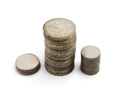 several stacks of coins stacked on top of each other on a white surface