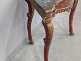 a small wooden table with a floral design on it