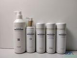 four bottles of lotion sitting next to each other on a table