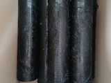 four rolls of black plastic wrapped in a box
