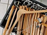 wooden clothes hangers in a black box on a tiled floor