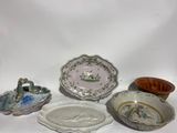 many different plates and bowls on a white surface
