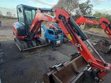 two small machines that are sitting in the dirt