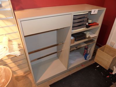 a white cabinet with drawers and shelves in the corner of a room