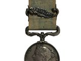 une image d'une médaille entourée d'un ruban sur fond blanc