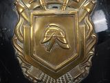 a black helmet with a gold emblem on it
