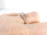 a person holding a diamond ring on their finger