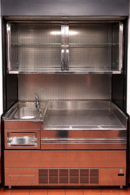 a stainless steel refrigerator with two sinks in it