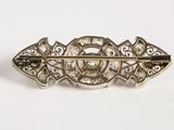 an image of a silver broochle with diamonds on it