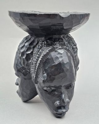 an image of a sculpture of a bear with a bowl on its head