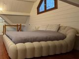 a bed in the middle of a room with a ceiling fan