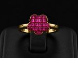 a gold ring with a pink stone in the center