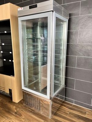 a glass display case in the corner of a room