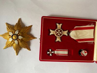 a red case with a gold star and a medal