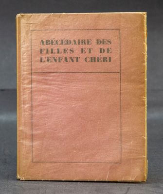 an old book sitting on top of a table next to a black background