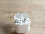 a clear box with a pair of airpods in it